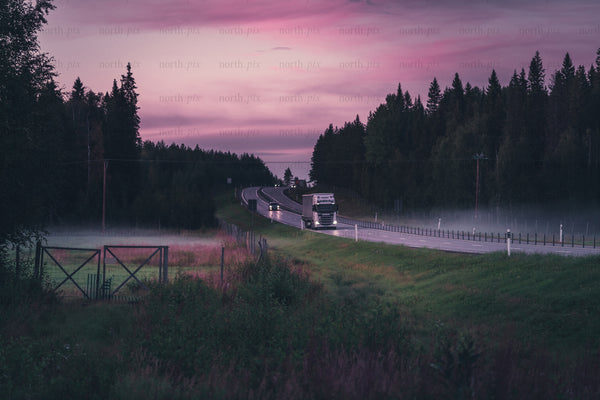 Truck on rural highway at sunset