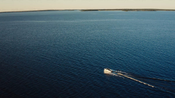 Summer in Luleå archipelago: Motorboat cruising on a bright day
