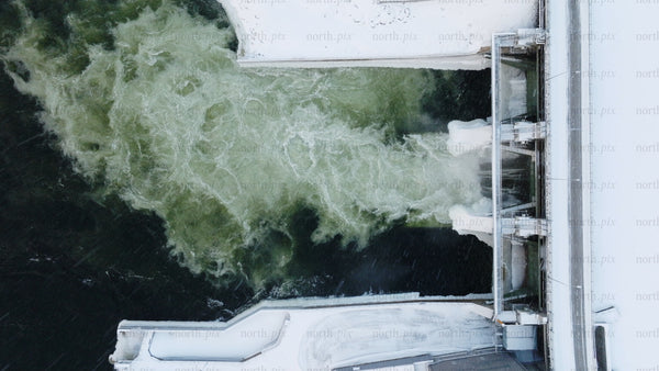 Hydroelectric dam water flow: Aerial view of renewable energy in winter