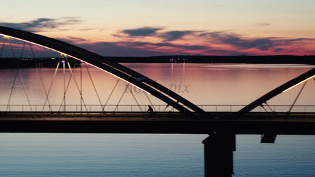 Sunset Bike Ride Across Luleå Bridge: A Serene Aerial View of Summer in Sweden