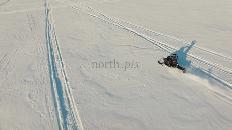 Snowmobile Adventure on Frozen Lake in Luleå, Sweden: A Sunny Winter Day