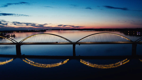 Aerial dusk view of Luleå's Bergnäsbron bridge: Calm waters and twilight sky