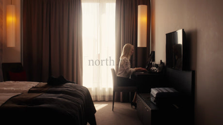 Businesswoman Working on Laptop in Hotel Room in Lulea, Sweden