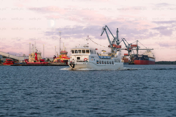 Passenger ferry in harbor at dusk