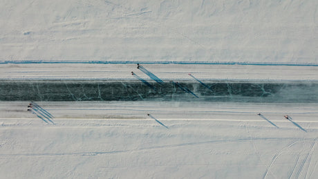 Aerial View of Frozen River in Lulea, Sweden With People Skating and Walking in Winter