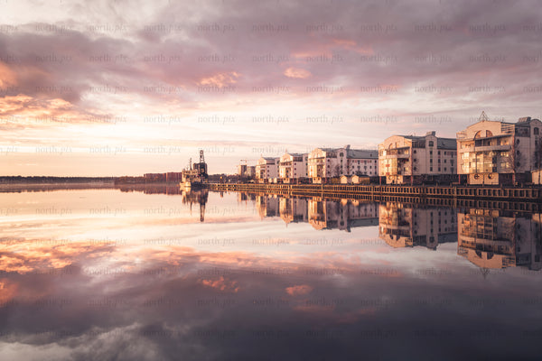 Waterfront apartment buildings "tuttifrutti" reflected in calm sunset water