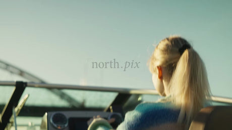 Young Woman Boating in the Luleå Archipelago at Sunset During Summer