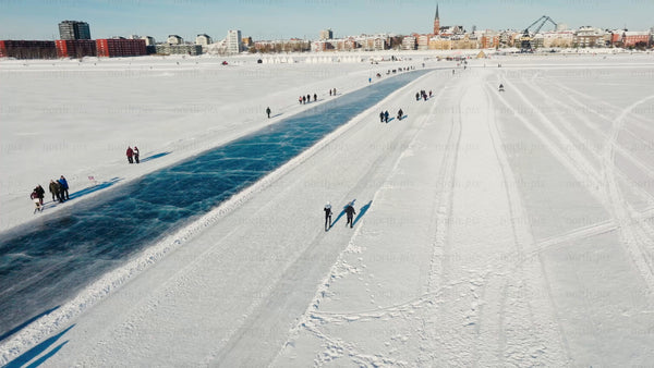 Winter day in Luleå: People enjoy skating and walking on a frozen waterway