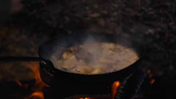 Cooking meat and potatoes over an open fire in winter, Luleå archipelago