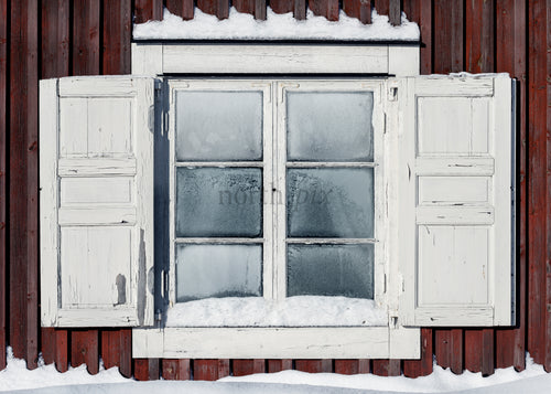 Old wooden window with shutters and snow