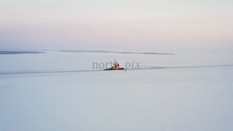 Icebreaker Navigating Frozen Waters of Luleå Archipelago at Sunset