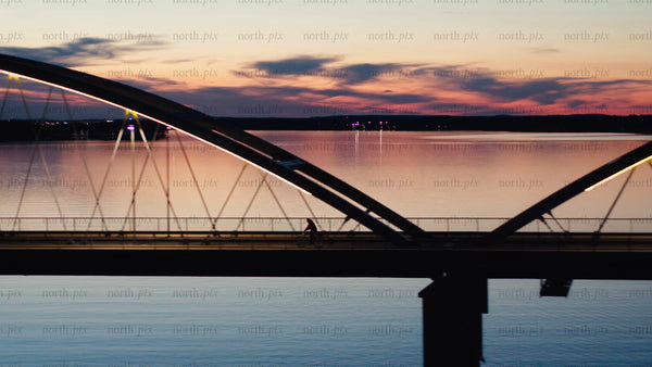 Sunset bike ride across Luleå bridge: An aerial view of summer