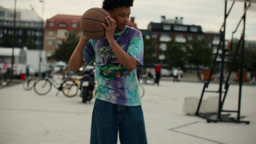 Unga män spelar en-mot-en-basket på en urban plan i Luleå, Sverige