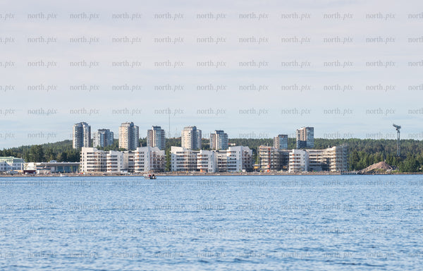 Waterfront apartment buildings on coastline at midday