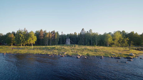 Summer Evening Drone View of Windmill on Forested Island in Luleå Archipelago, Sweden