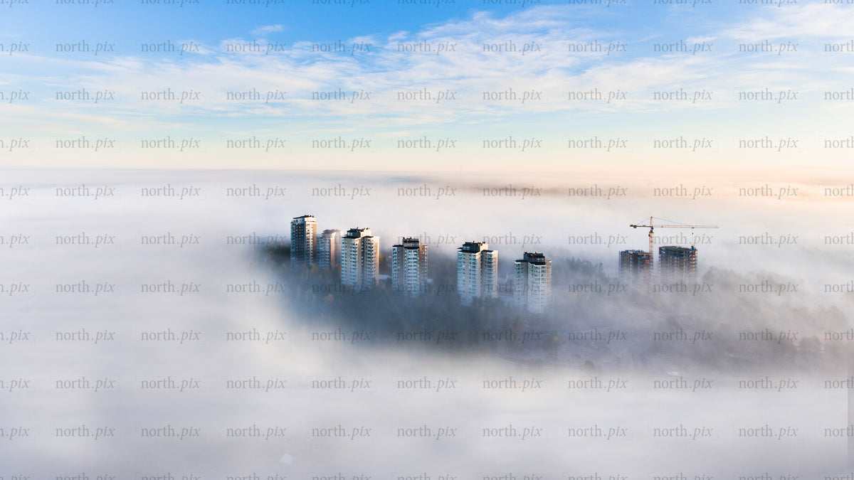Drone view of Luleå high-rise buildings in morning foggy urban landscape