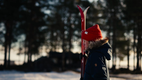 Winter Day in Luleå: Person Walks Across Snowy Landscape with Skis