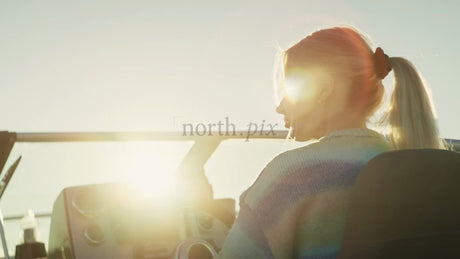 Woman Driving Boat at Golden Hour in the Luleå Archipelago, Sweden