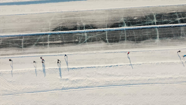 Winter ice skating on frozen lake in Luleå - aerial drone view