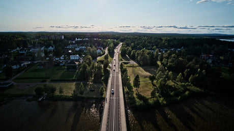 Aerial View of Lulea, Sweden: Summer Evening Drive Over Bridge, Lush Green Landscape