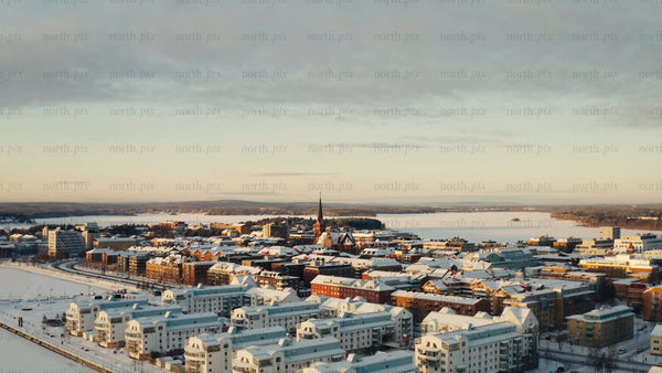 Winter sunrise over Luleå: Aerial drone footage of snow-covered city