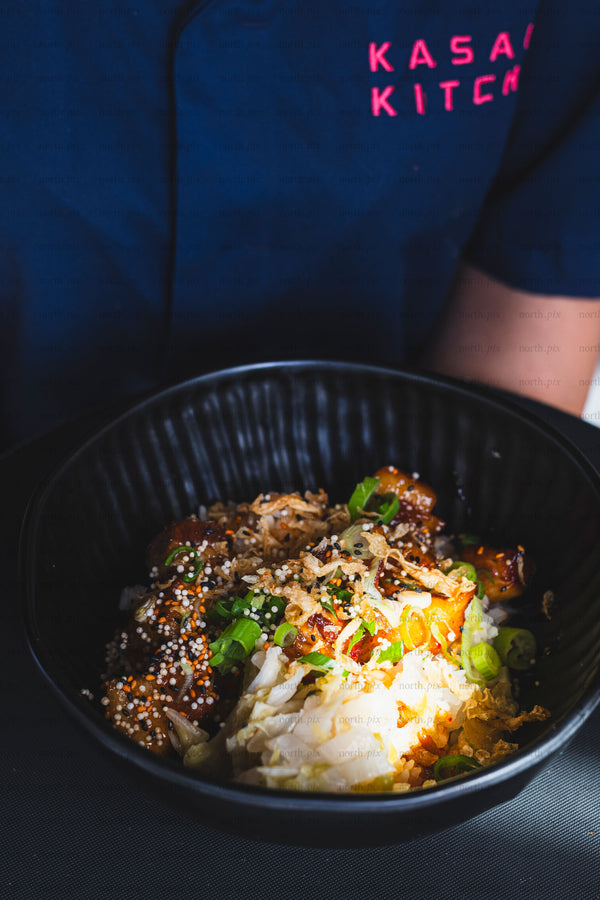 Rice bowl with grilled chicken and pickled cabbage, close-up