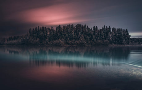 Twilight Lake Reflection With Pine Forest Island and Moody Sunset Over Calm Water