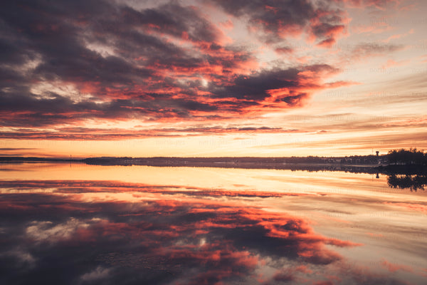 Sunset over Södrahamn harbor with mirrored clouds
