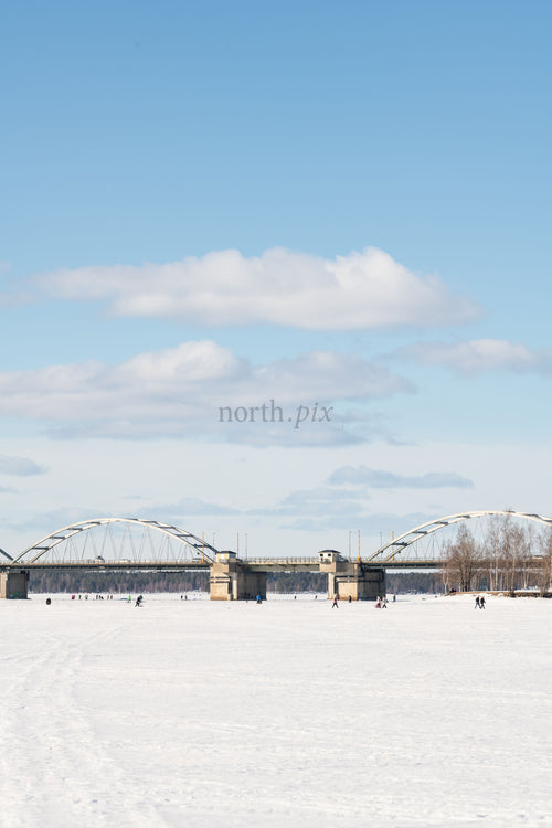 Bridge over a frozen river on a winter day