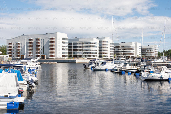Marina with waterfront apartment buildings at midday