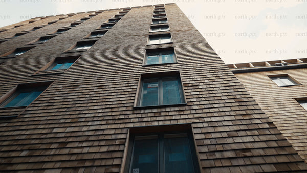Modern wood architecture: High-rise apartment building with tile facade