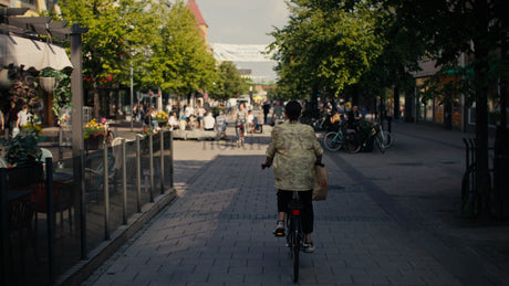 Woman on Bicycle in Lulea City Center During Sunny Summer Day