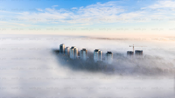 Drone view of Luleå high-rise buildings in morning foggy urban landscape
