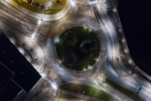 Aerial night view of Luleå city center roundabout with light trails and urban rings