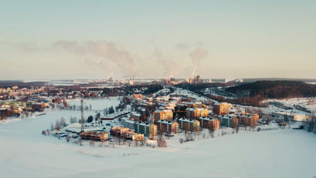 Aerial View of Lulea, Sweden: Winter Landscape, Industrial Area, and Residential Buildings at Sunset