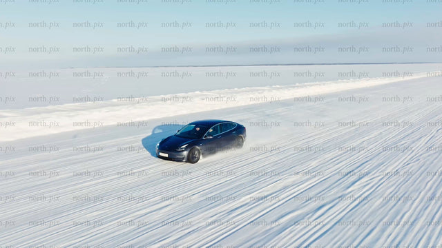 Tesla/car winter driving test on ice road in Luleå - drone footage