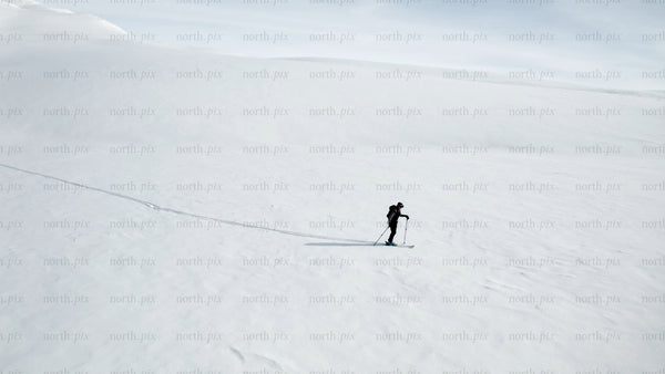 Lone skier in snowy mountain landscape