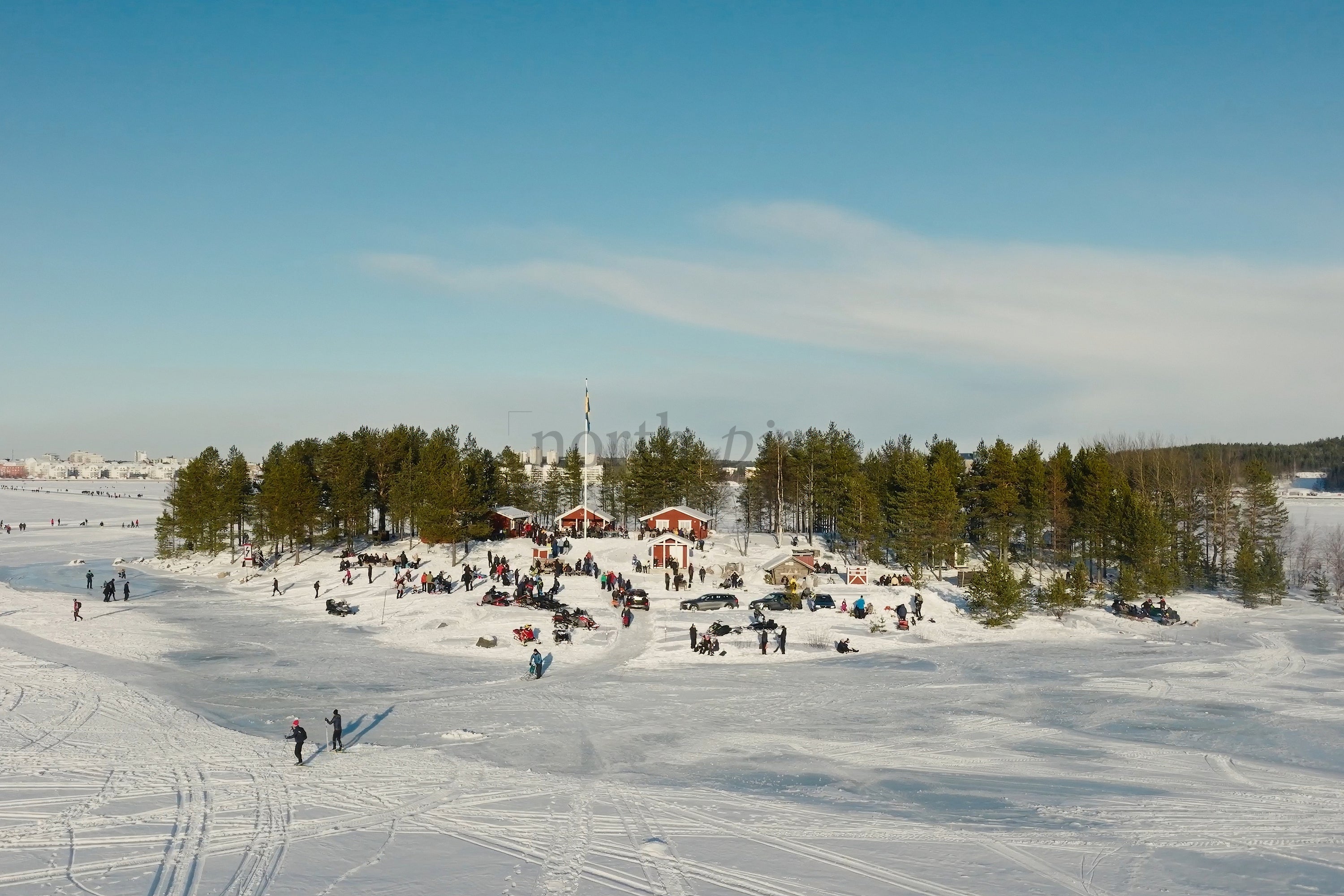 Snowy Luleå City Center Park With People Enjoying Winter Activities And Forested Islands