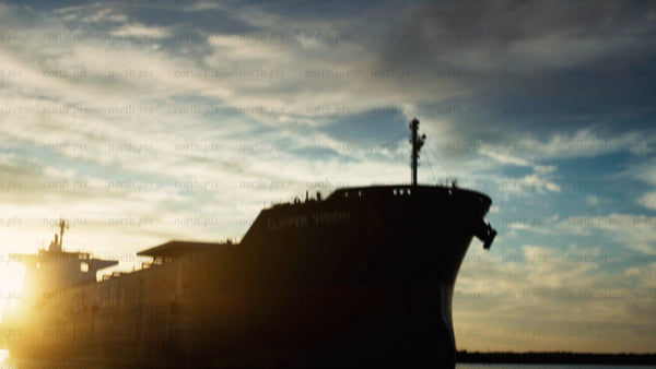 Cargo ship silhouette at sunset in Luleå