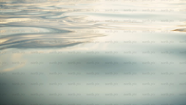 Calm water ripples at sunset: Golden hour reflections