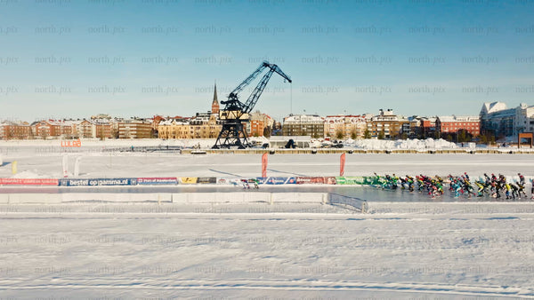 Winter snowmobile race on frozen lake in Luleå, drone view