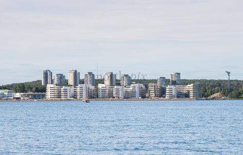 Waterfront apartment buildings on coastline at midday