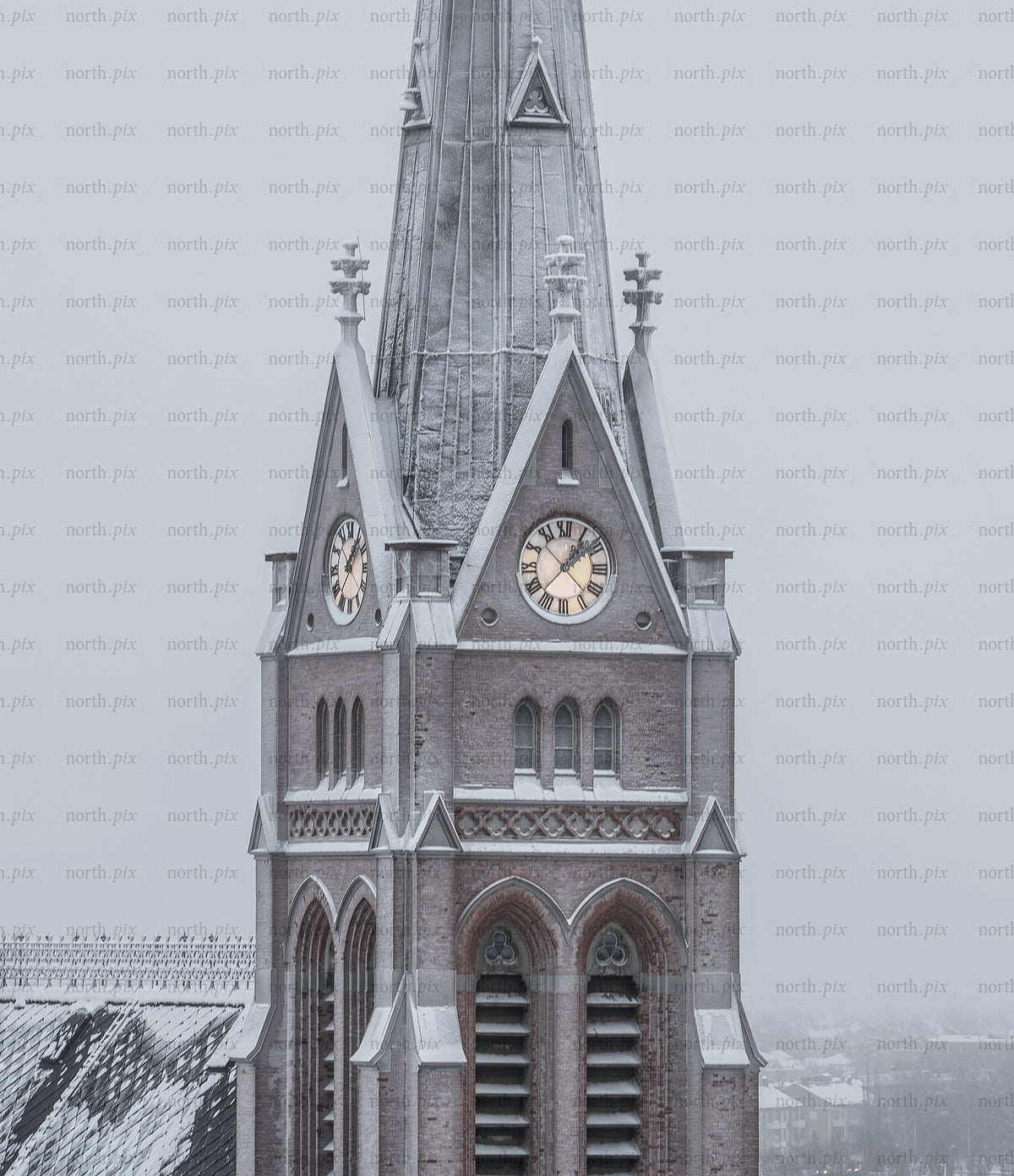 Church clock tower covered in snow on winter morning