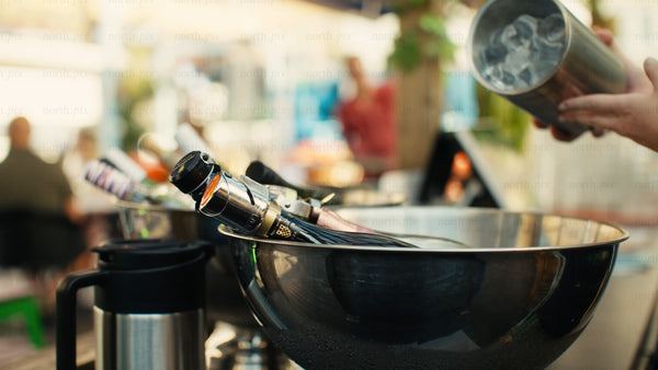 Cooling drinks in ice bucket at an outdoor summer party in Luleå