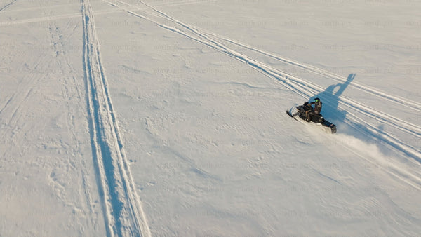 Snowmobile adventure on frozen lake in Luleå: A sunny winter day