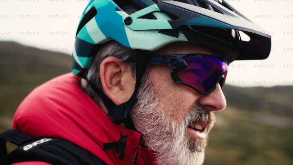Mountain biker smiles before downhill ride in nature