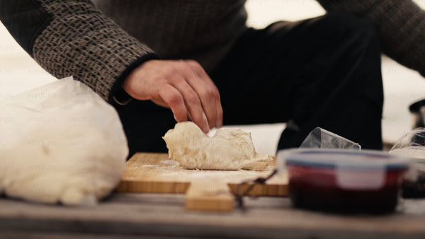 Man preparing dough for baking in winter, Luleå archipelago