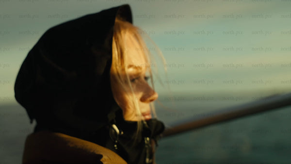 Woman on scenic boat trip in Luleå archipelago during golden hour