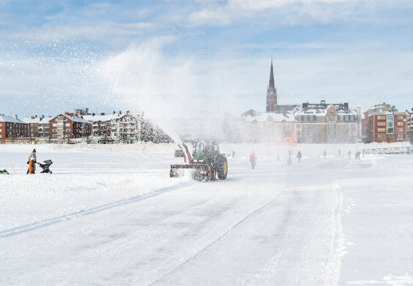 Tractor snow plow on frozen sea ice, Luleå winter
