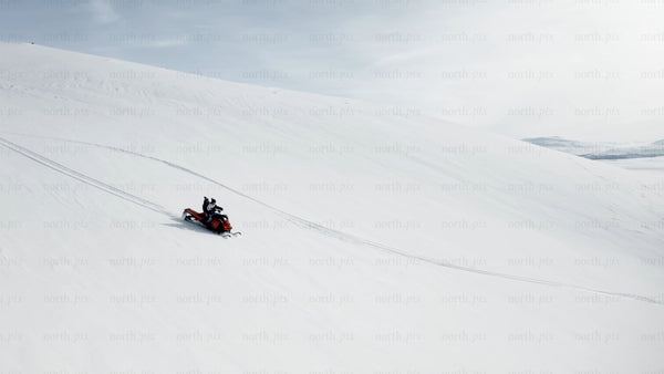 Snowmobiling adventure: Two people riding in a winter wonderland